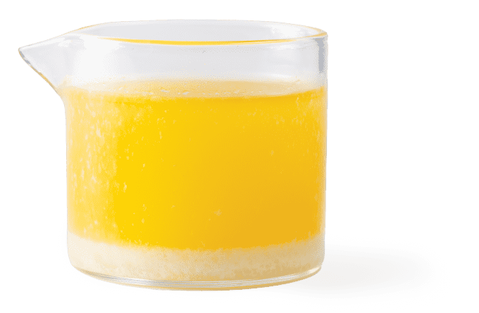 A container of bright yellow clarified butter.